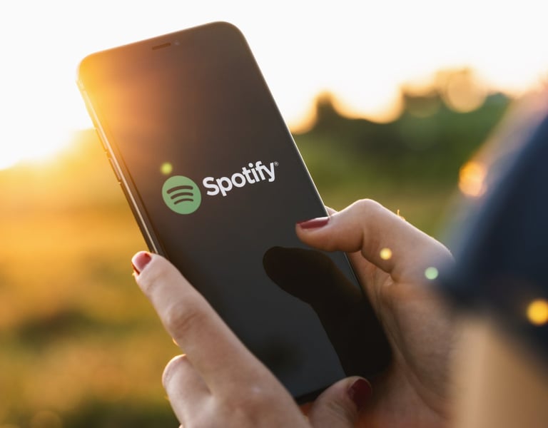 Person holding up phone with Spotify