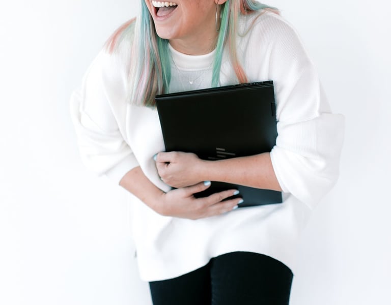 tabitha with butterfly effect consulting laughing with her laptop