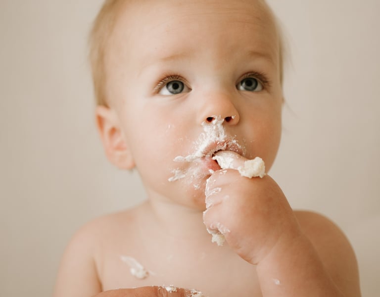 baby eating cake at his cake smash photography session in Adelaide Hills