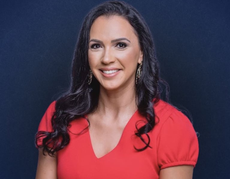 a woman in a red dress smiling at the camera