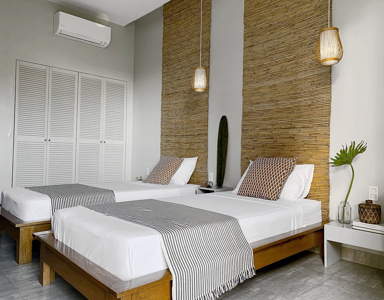 a bedroom with two beds and a surfboard