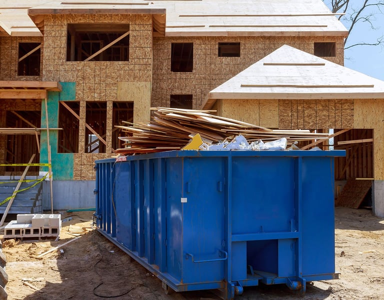 construction trash piled in container