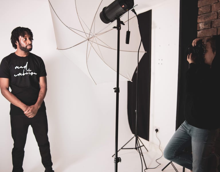 a man standing in front of a camera and a woman