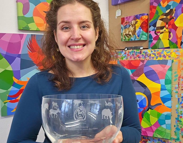 Award winning artist Tanja Hassel smiling proudly, holding Pollyanna Pickering award