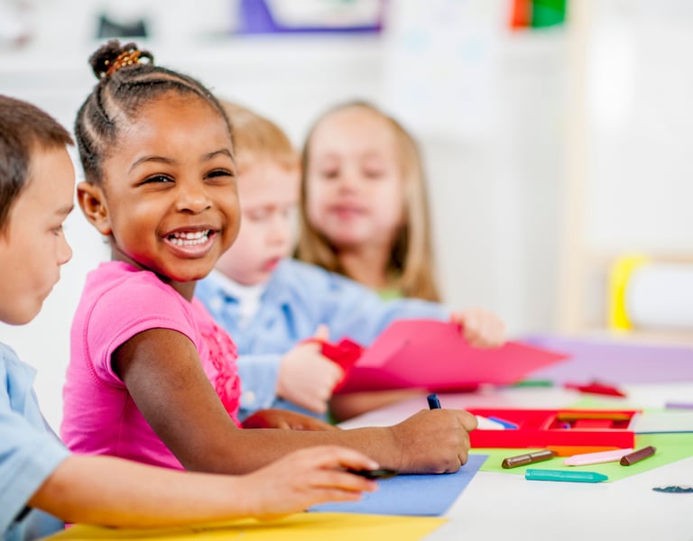 Children smiling and coloring