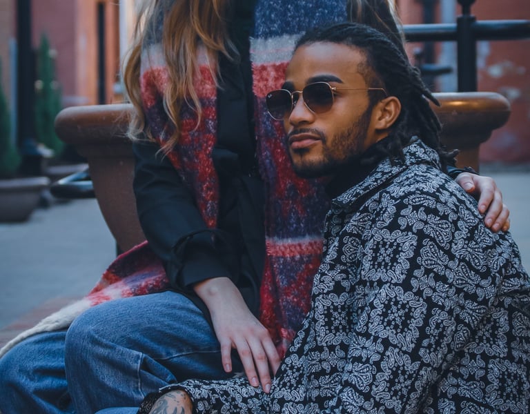 Two young adults wearing fashion sunglasses in an alley of Fort Collins, Colorado