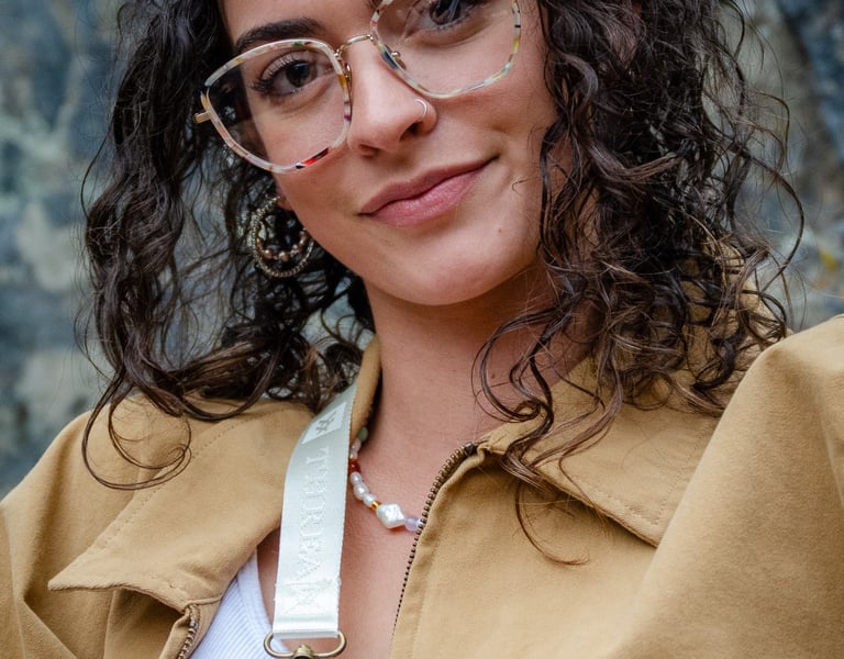 Woman wearing fashionable eyeglass frames, smiling