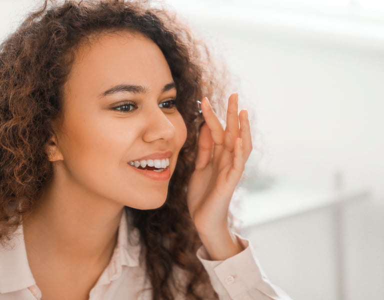 Woman smiling while putting in a contact lens
