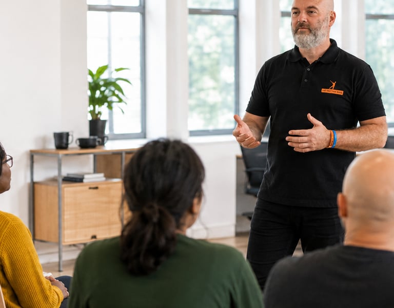 A corporate trainer guiding an interactive workplace mental health workshop 