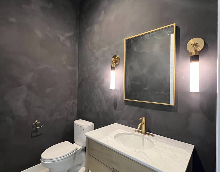 Moody black limewash bathroom with a textured matte finish, creating a sophisticated and modern spa-