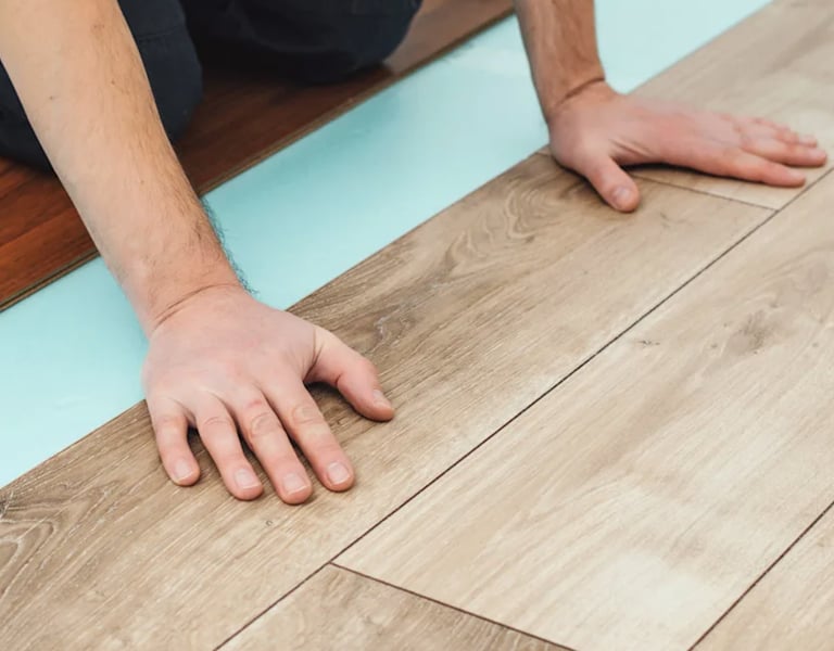 Flooring installer is installing floating type flooring.