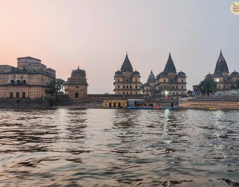 Scenic view of Orchha's royal cenotaphs from a boat on the Betwa River.
