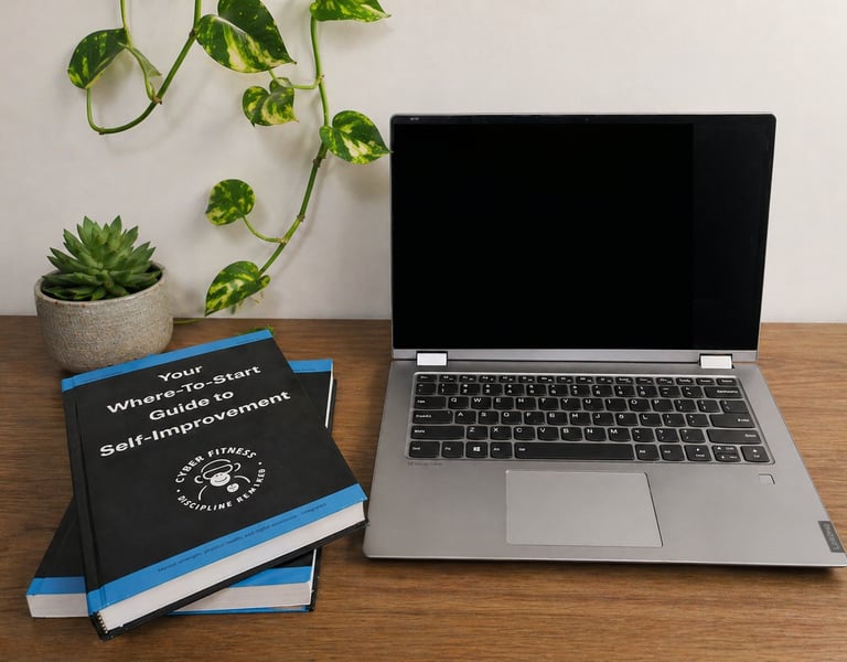 Laptop on a desk with copies of the CFDR handbook
