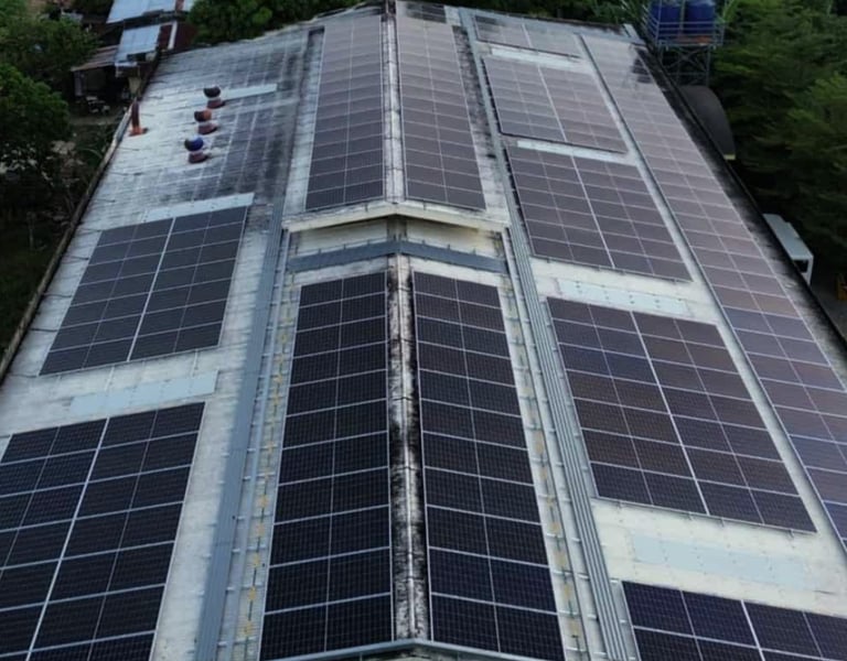Aerial view of a commercial building rooftop with an installed solar panel system for renewable energy.