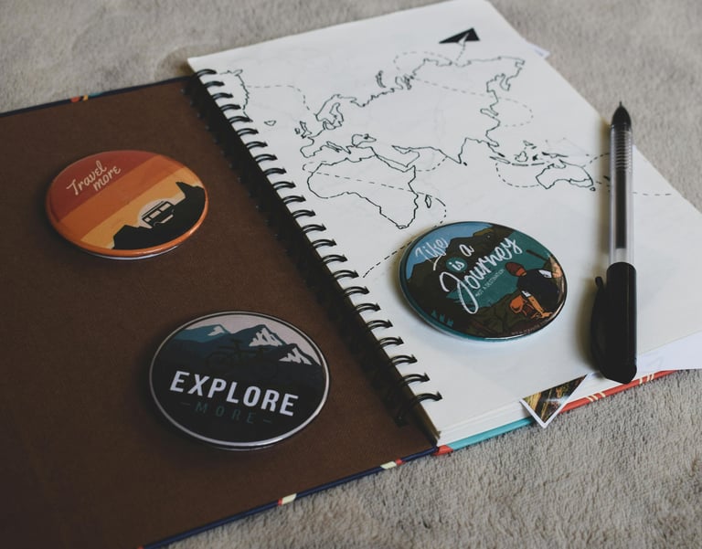 a notebook with a pen and a notebook with a map of the world