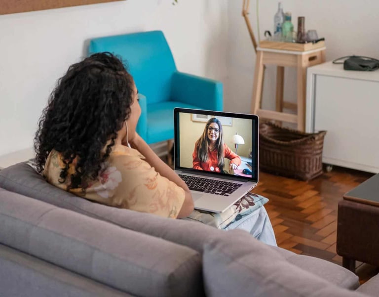 a woman sitting on a couch with a laptop computer