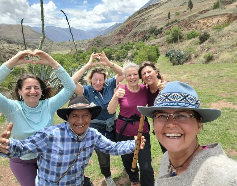 a group of people standing infront of the south gate of Cusco Valley