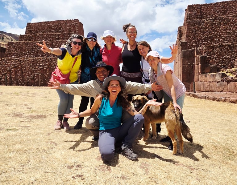 a group of people posing for a picture in the south gate of Cusco