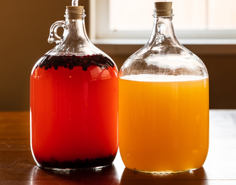 Two jugs of liquid (mead), one orange and one gold