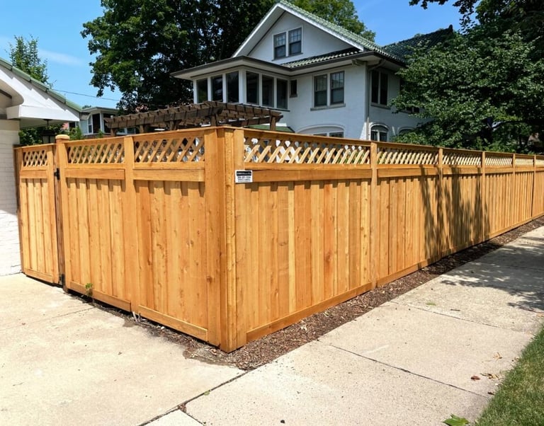 Custom wood privacy fence with lattice top installed in a Long Island residential neighborhood.