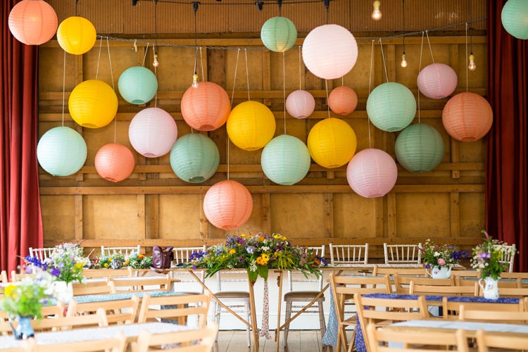 a wedding reception table with paper lanterns