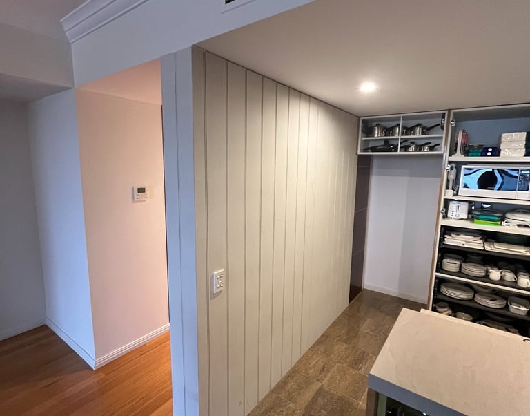 Before and after interior renovation with custom timber wall cladding