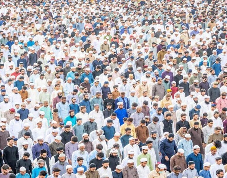 Large group of people gathered in prayer, standing closely together