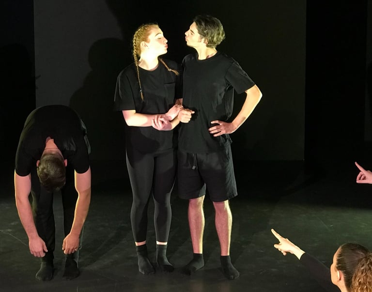a group of people standing around a man in a black shirt
