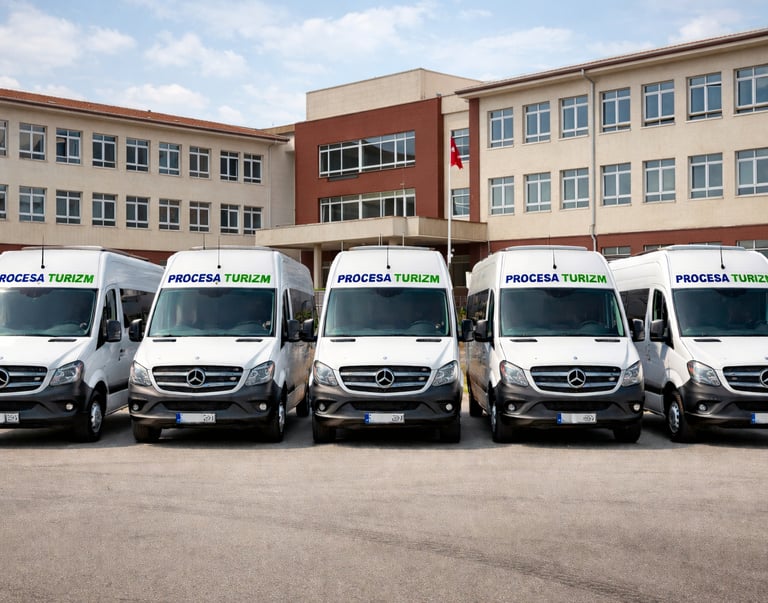 A fleet of white Mercedes-Benz Sprinter shuttle vans for Procesa Turizm transport services.