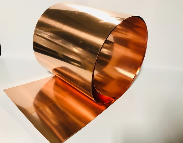 a copper plated metal object with a wine bottle