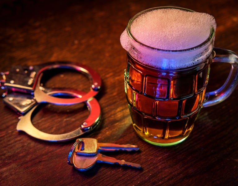 keys, handcuffs, and beer on table