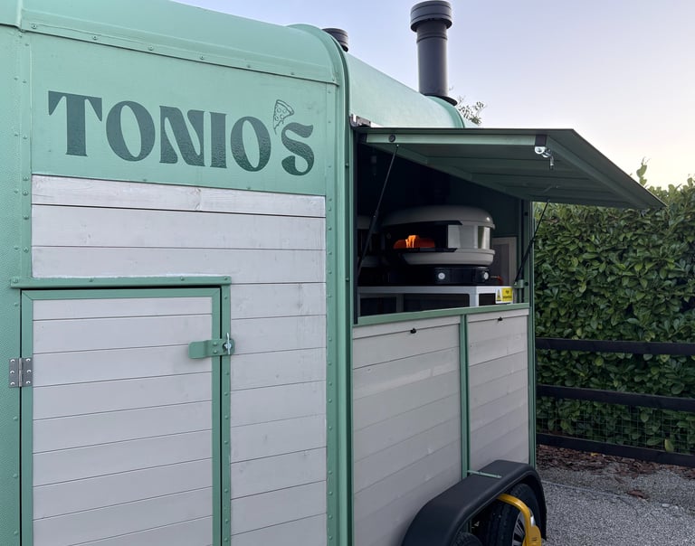 Tonio's green mobile pizzeria trailer