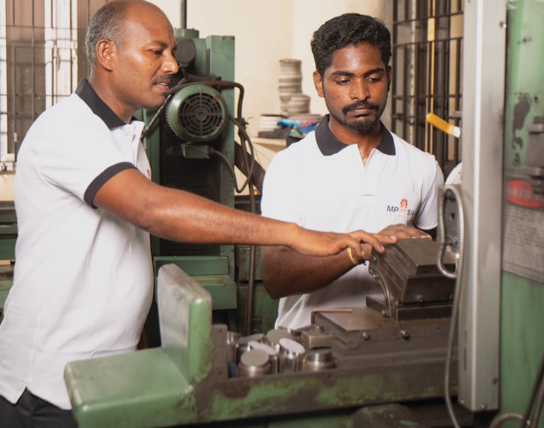 MP Asia Engineering staff working on CNC machine