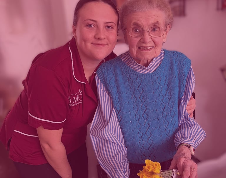 Image of an AMG nurse with an elderly patient 