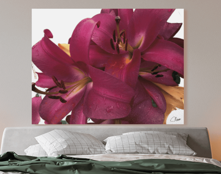 Wall Canvas Print with Lily Flowers printed on it above a bed with pillows and bedding on it