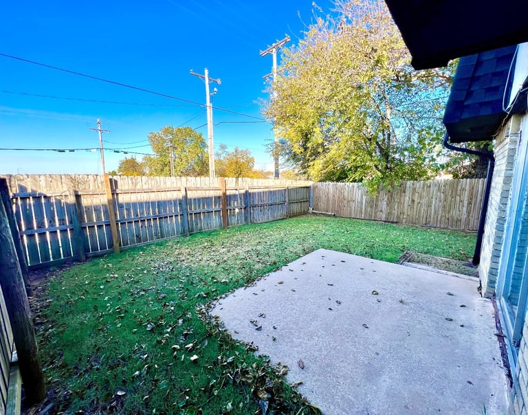 a spacious and green private fenced-in backyard