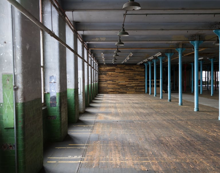 Main room image showing the wooden floor and revered Pallet Wall
