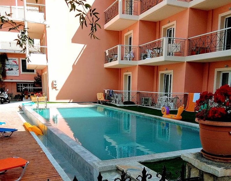 a pool with a pool and chairs and a fenced in area