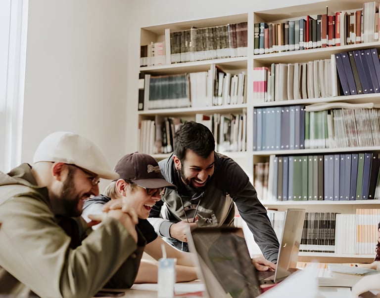 Three men in a library engaged in a discussion about studying abroad