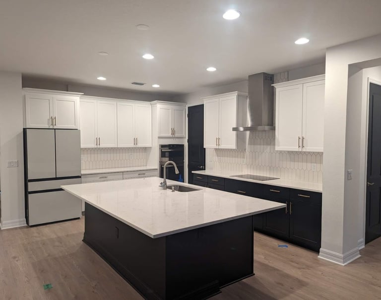 a kitchen with a large island and a refrigerator