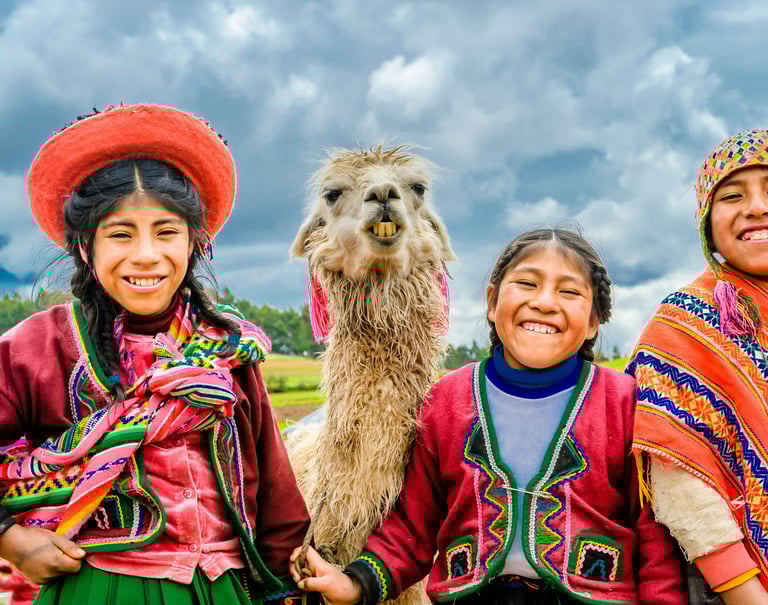 two happy kids from the Andes with a llama. Dos ninos felices de los Andes con una llama