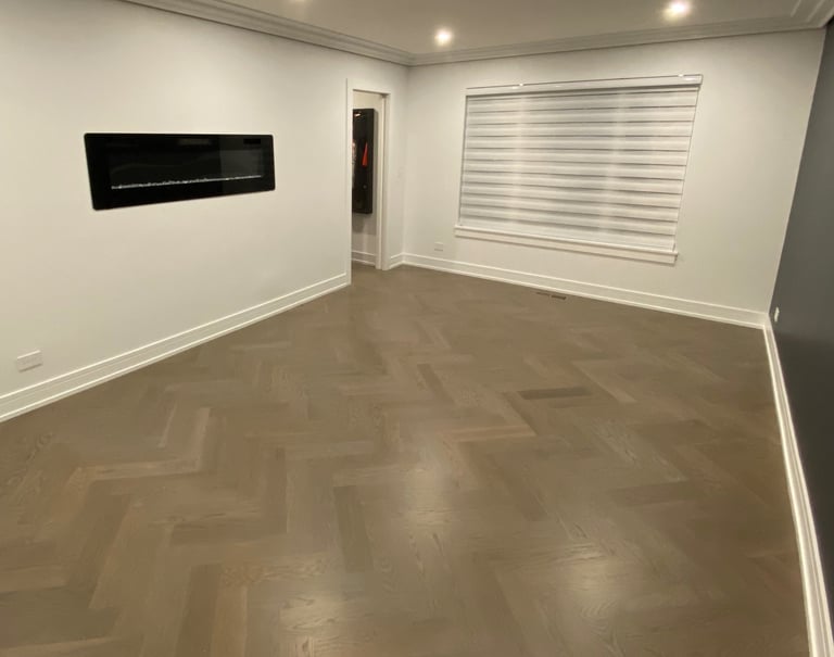 Custom herringbone hardwood flooring installation with modern fireplace in a Chicago North Shore home