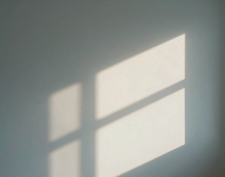 Conceptual interior photography of a minimalist room. A single ray of light hits an off-white wall, creating sharp geometric shadows. Soft slate blue tones in the shadows.