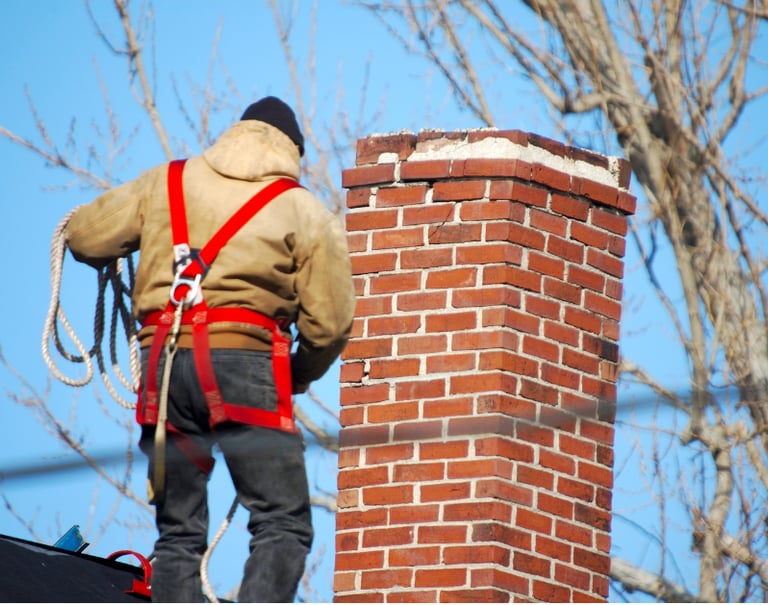 Man on roof chimney repair