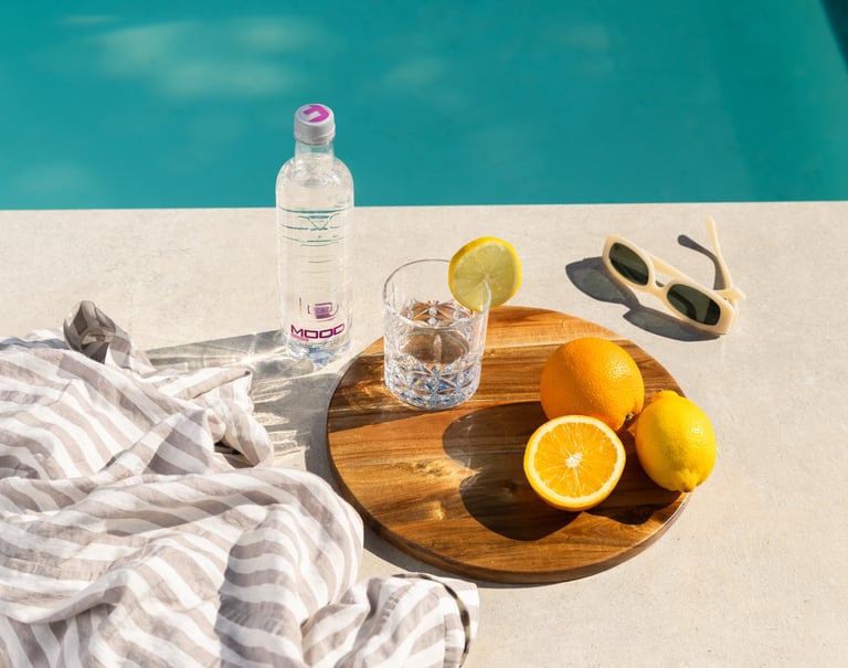 bottiglia d'acqua di design con bicchiere e limoni