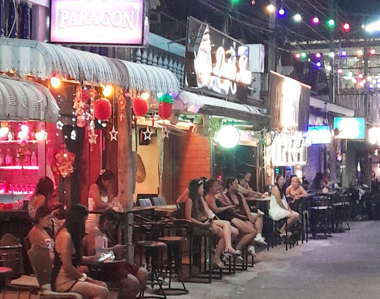 Thai women sat ouside bars on Soi 80, Hua Hin in Thailand