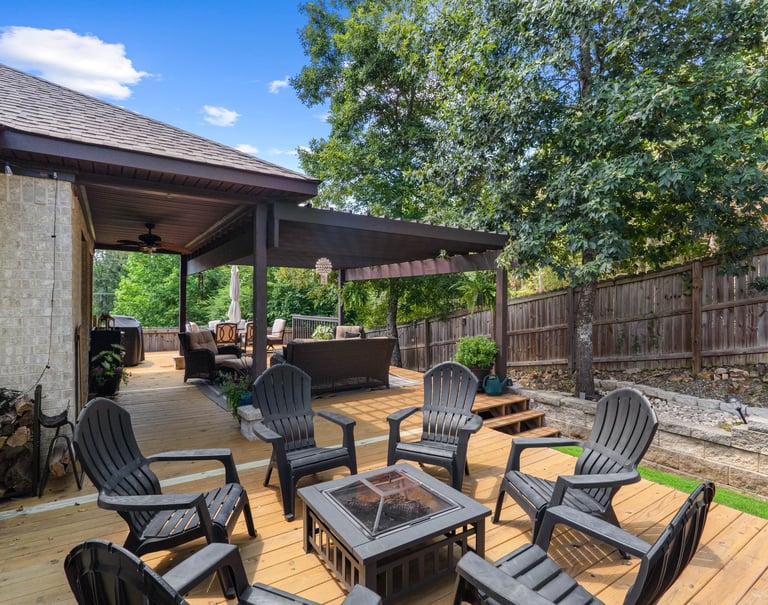 a patio with a fire pit and chairs