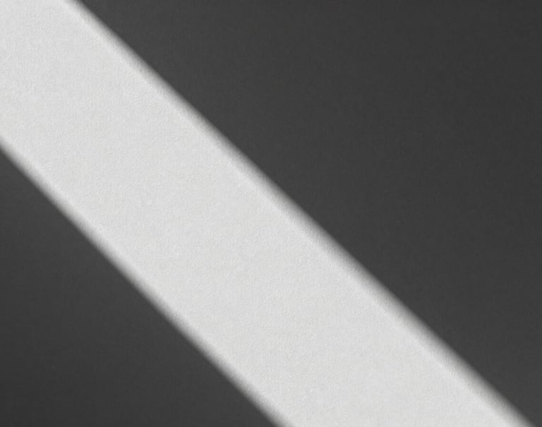 A black and white photography study of light hitting a textured wall. Geometric shadows divide the frame. Contemporary minimalist style with high contrast between #0A0A0C and #F5F7FA.