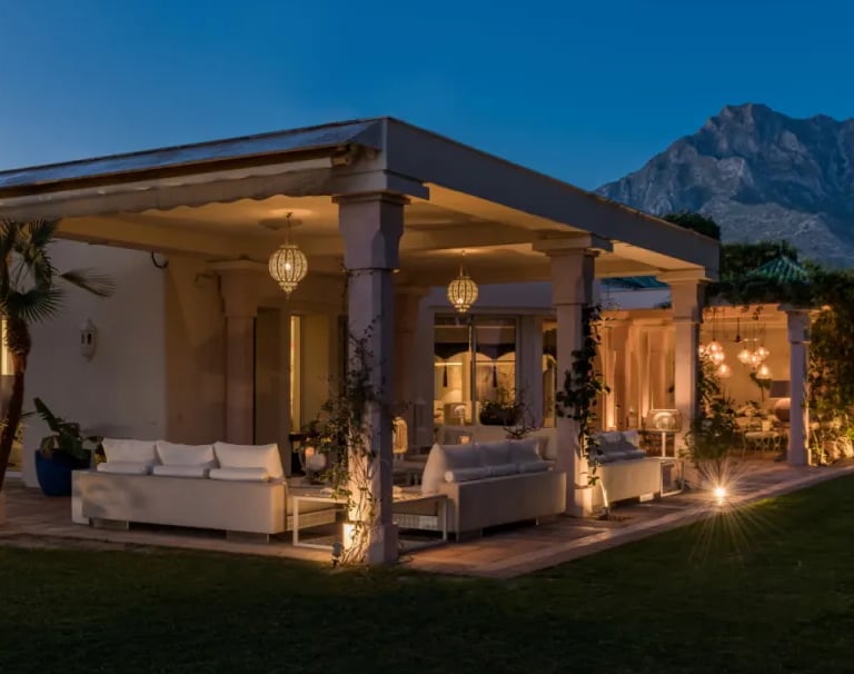 Illuminated pavilion at Villa El Rincon against the mountains