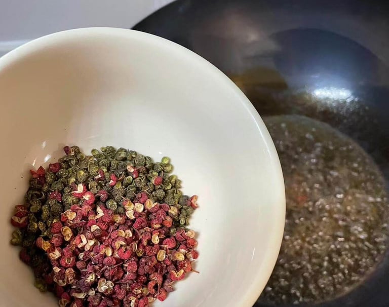 a person holding a bowl of Sichuan Peppers in a bowl